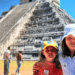 two young girls in front of chicken itza ruins in Mexico.