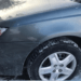 Michelin snow tires on a grey car close up of the tires in driveway ice and snow on the ground