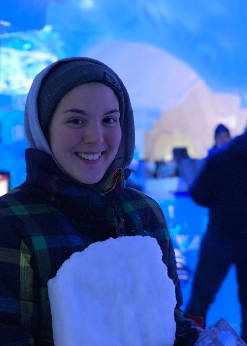 teen_holding_snowy_chunk_to_sculpt_at_night