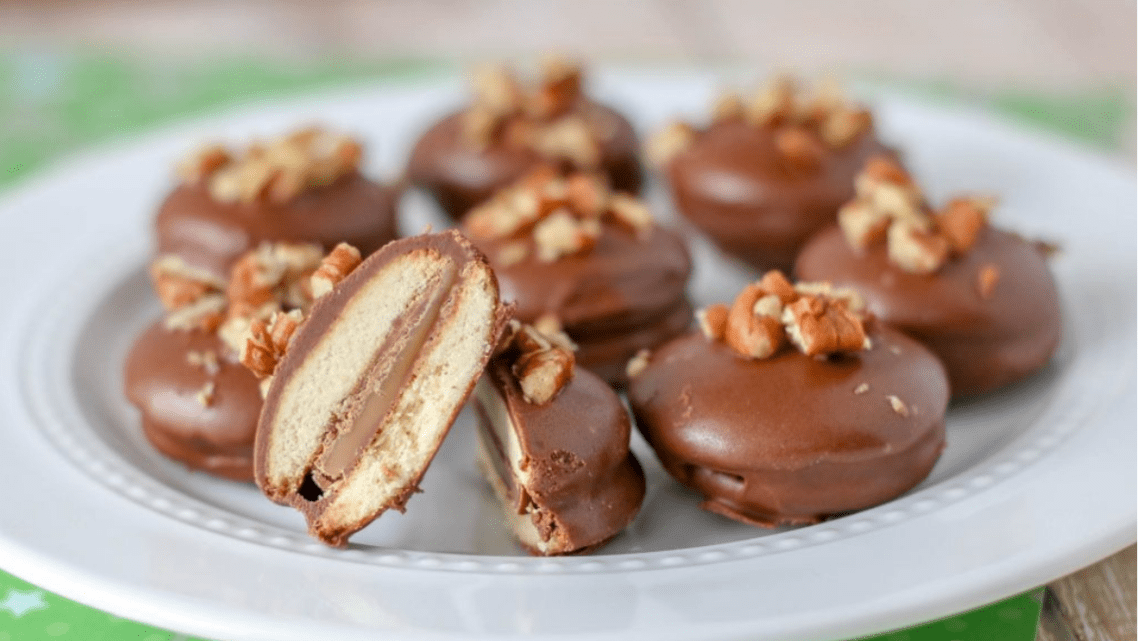 Nilla wafer with nuts on top of chocolate on a plate