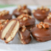 Nilla wafer with nuts on top of chocolate on a plate