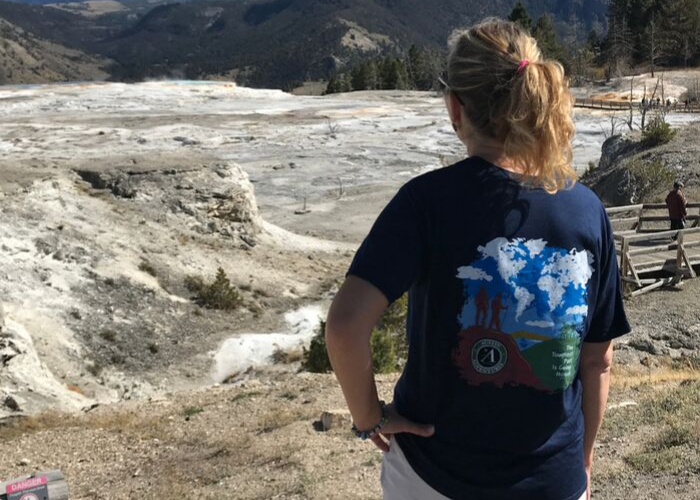 woman looking out over Mammoth Hot Springs at top of the walkway