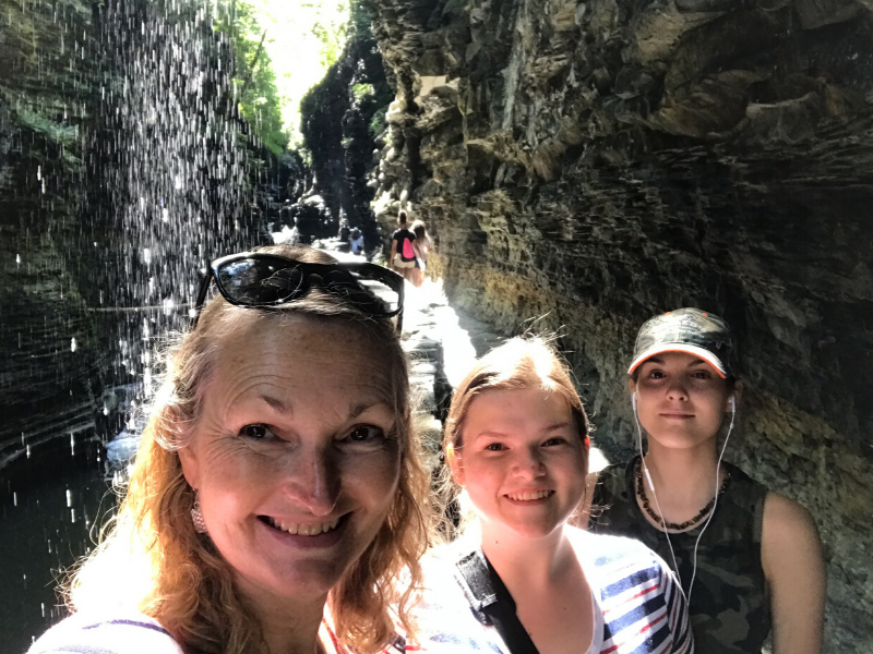three women in Watkins Glen state park in front of the gorge 