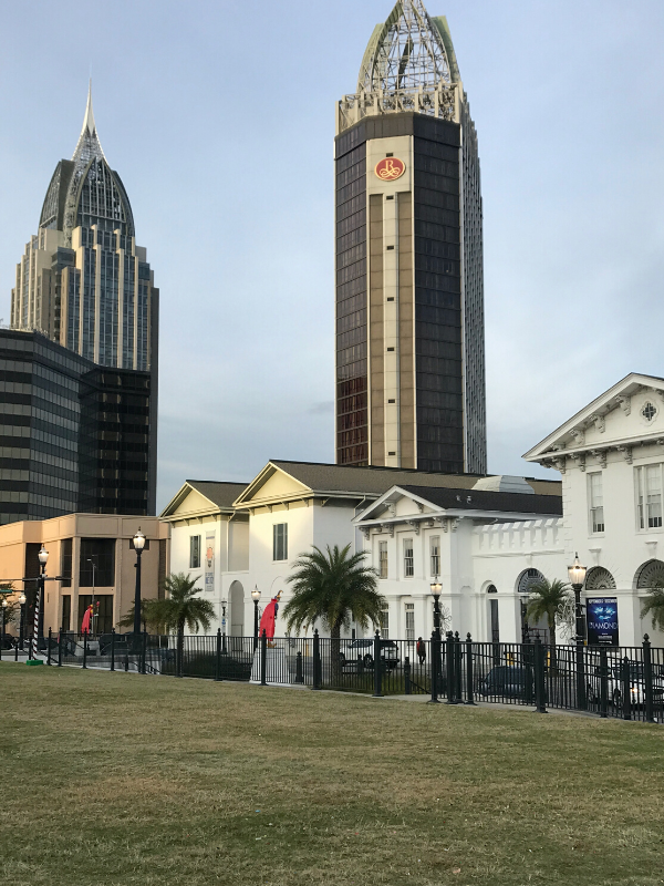 Mobile History Museum in foreground with Renaissance Riverview tall building in centre 