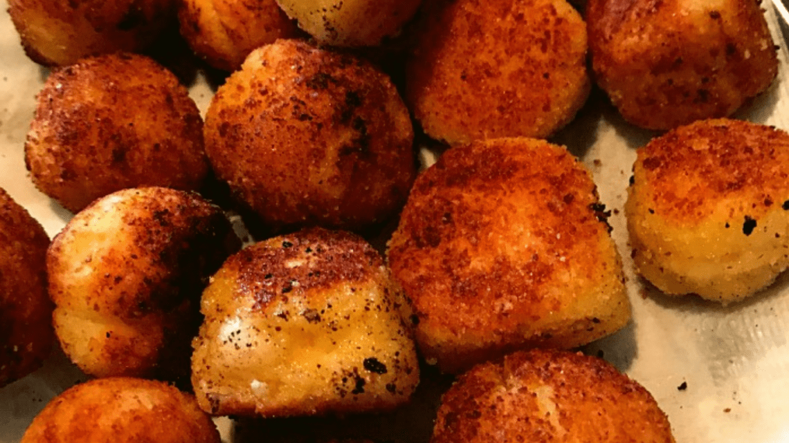 cheese ball appetizer coated with breading and browned perfectly