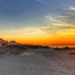 Gulf Shores Alabama sunset on the beach with cottages facing the shore