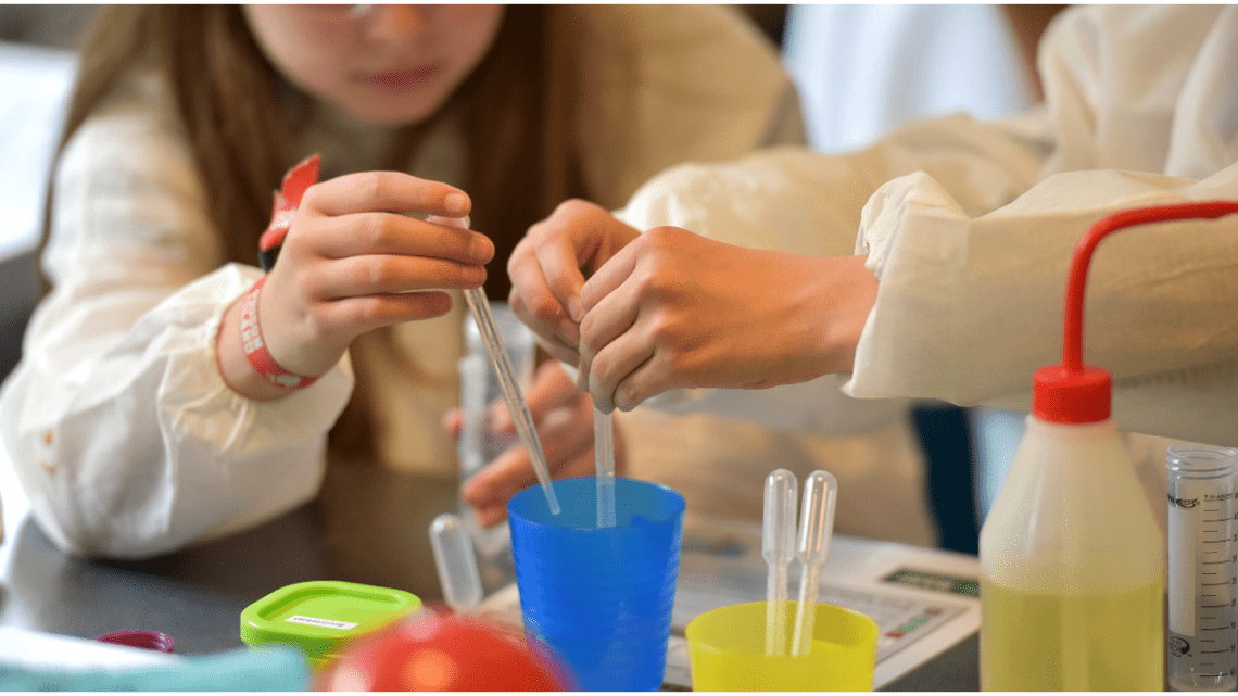 steam play and a young kid playing with plastic vials of liquids