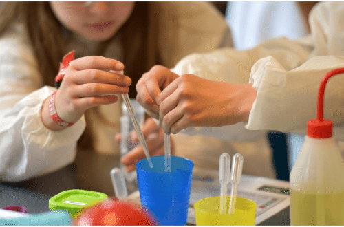 steam play and a young kid playing with plastic vials of liquids