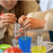 steam play and a young kid playing with plastic vials of liquids