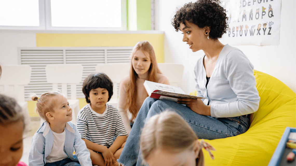 teacher reading to kids in a small classroom