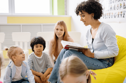 teacher reading to kids in a small classroom